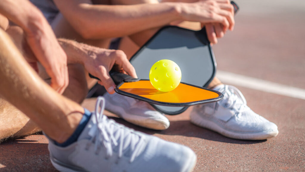 Pickleball Game Relaxing Pickleball Players Couple With Yellow Ball With Paddle Sitting After Game Outdoor Sport Leisure Activity Optimized